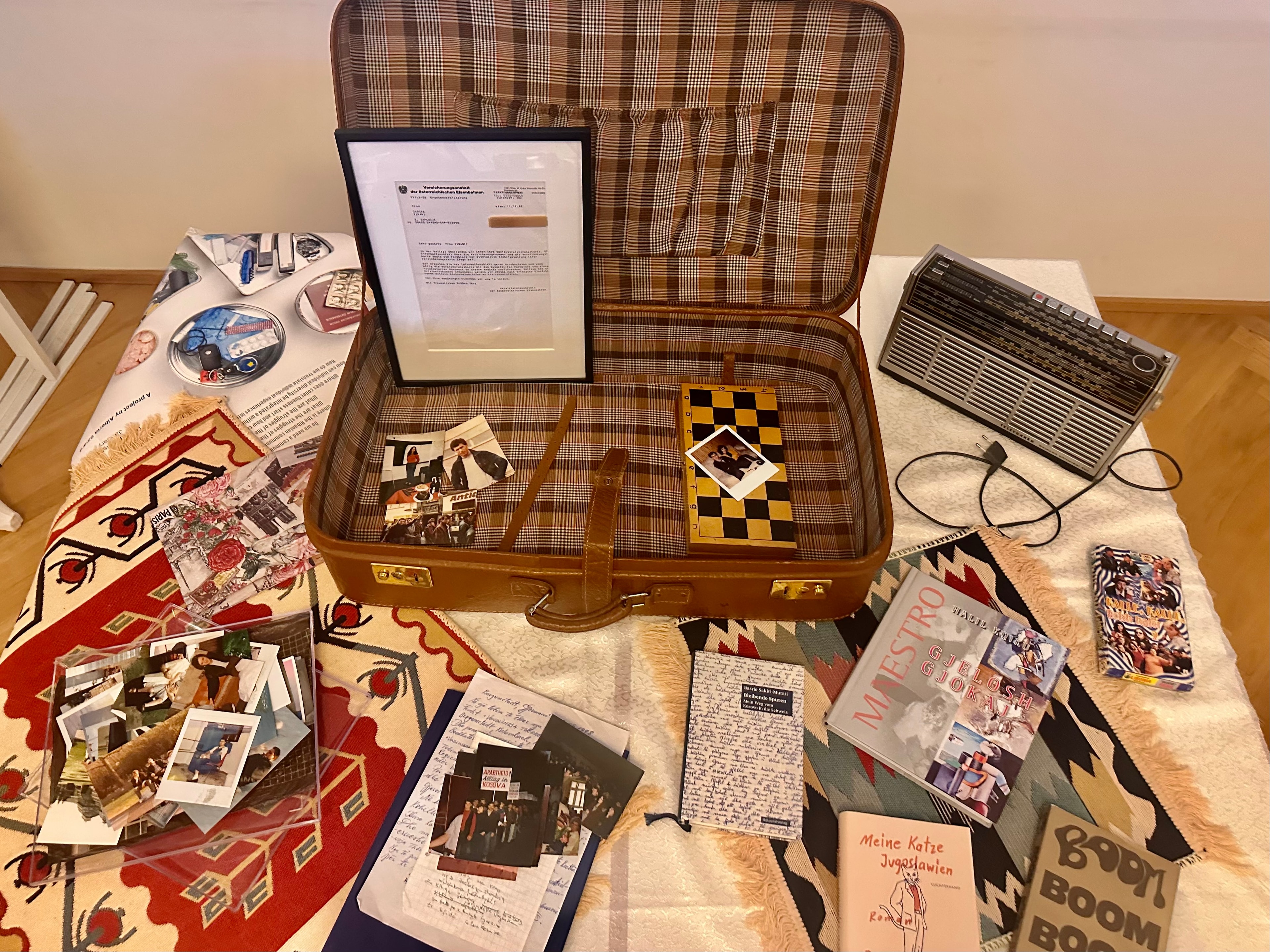 Suitcase installation with photographs, letters and memorabilia from the diaspora archive